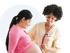A Female doctor listens with a stethoscope on a pregnant woman's belly